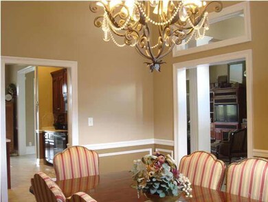 Formal dining room opens to the foyer and kitchen.