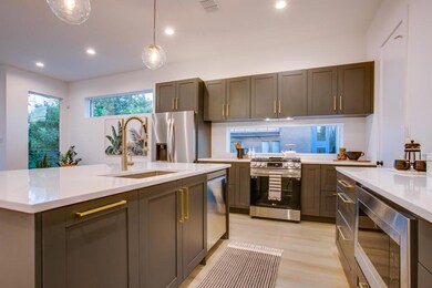 Kitchen with sink, a center island with sink, ligh