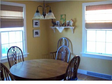 Inviting dining room with hardwood floors and a lo