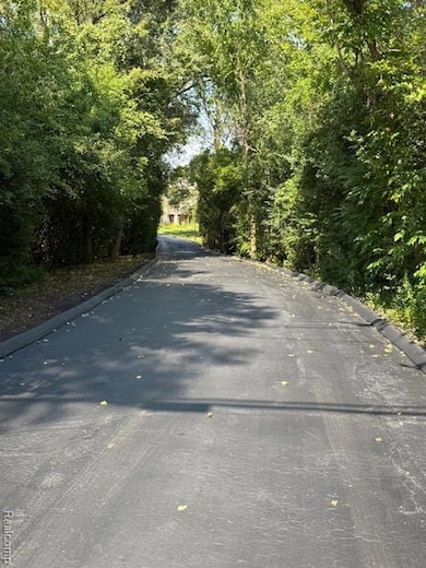 View of asphalt road with curbs
