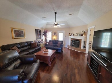 The living room is spacious, offers a wood-burning