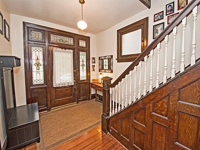 Front foyer is full of light with beautiful staine