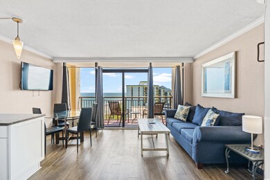 Living room with floor to ceiling windows, crown molding, a textured ceiling, dark wood-type flooring, and a water view