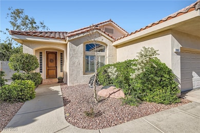 Entrance to property with stucco siding and a tile
