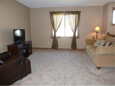 A large living area, new carpet, lots of light.
