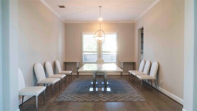 Spacious formal dining room with modern light fixt