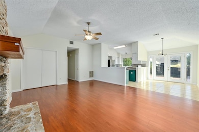 Unfurnished living room with vaulted ceiling, lig