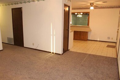 Formal living room with kitchen and family room in