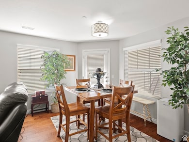 Dining space featuring wood finished floors and baseboards