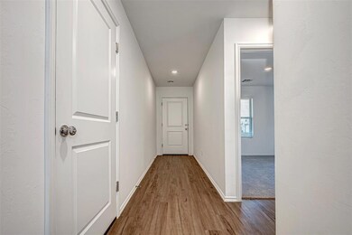 Corridor with wood finished floors and baseboards