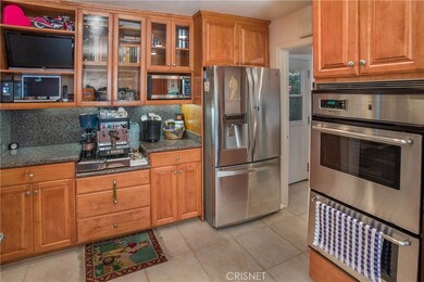 Chef's kitchen, beautiful cabinets with granite counters, stainless appliances, refrigerator, Espresso machine