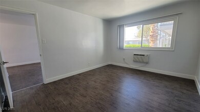 Empty room featuring dark wood finished floors, a