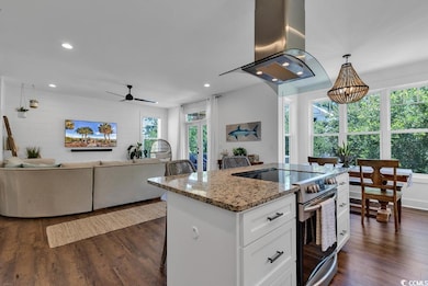 Kitchen featuring white cabinets, island exhaust h