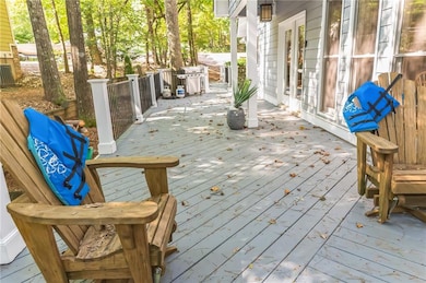 Wooden terrace featuring a grill