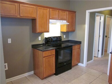 The kitchen has tile flooring and an eat-in area.