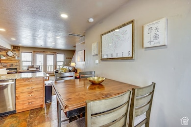 Dining room featuring recessed lighting, a textured ceiling, and a fireplace
