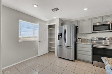 Kitchen with stainless steel appliances, baseboard