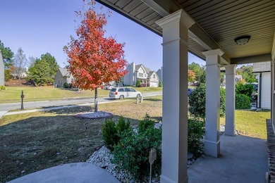 Covered porch featuring a yard and a residential view