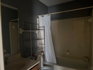 Bathroom with toilet, shower / bath combination wi