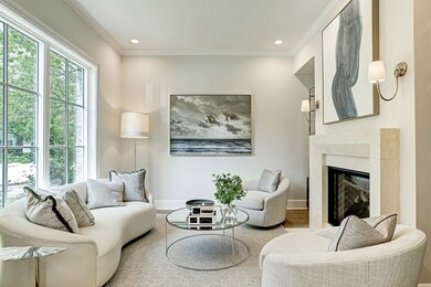 Light & bright library excludes elegance with gleaming hardwoods and high ceilings surrounded by a cast stone gas log fireplace. Notice the beautiful windows that overlook the front garden as well as provide ample natural light throughout.