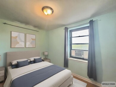 Bedroom with wood finished floors and baseboards