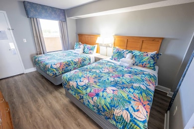 Bedroom with dark hardwood / wood-style flooring