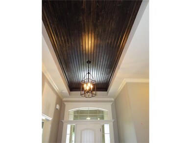 Foyer with 14 foot tall entry and wood trimmed cei