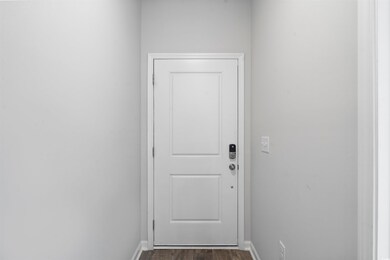 Entryway with dark hardwood / wood-style flooring