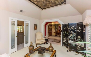 Formal living room features a tray ceiling and acc