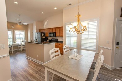 Dining space with wood finished floors, baseboards