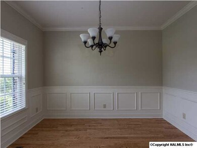 A SPACIOUS FOYER AND DINING ROOM GREET YOUR GUESTS IN STYLE. ATTRACTIVE TRIM AND DECORATIVE WAINSCOTTING ADORN THE WALLS.