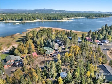 Aerial view of property's location with a heavily wooded area and a nearby body of water