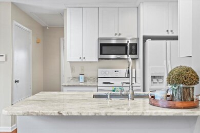 Kitchen featuring light granite counters and white