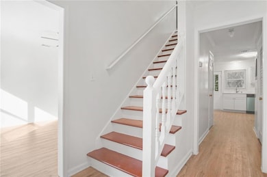 Staircase featuring wood finished floors