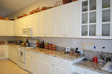 Kitchen features numerous cabinets.