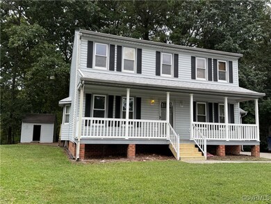 View of front of home featuring a storage unit, a