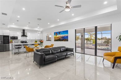 Living room with a tray ceiling, marble finish flo