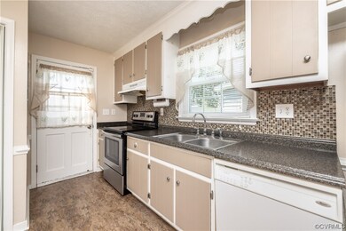 Kitchen featuring natural light, fume extractor, d