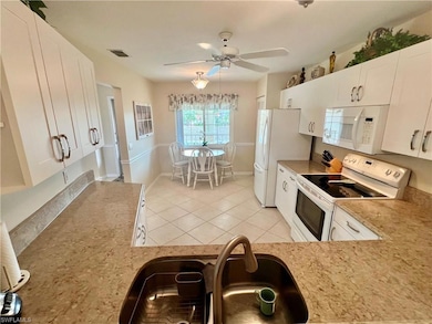 Kitchen with visible vents, light countertops, whi