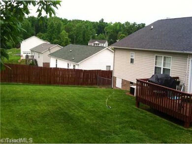 Exterior Back. Privacy fence with chain link side kennel. Large relaxing 12 x 10 deck.