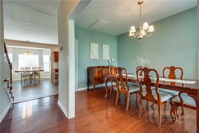 FORMAL DINING ROOM OVER HARDWOOD FLOORS.