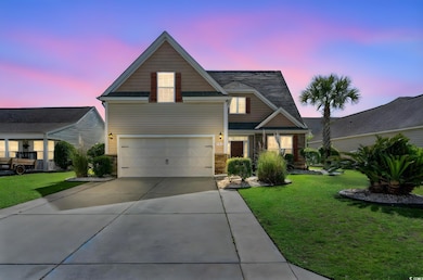 View of front facade with driveway, a front yard, 