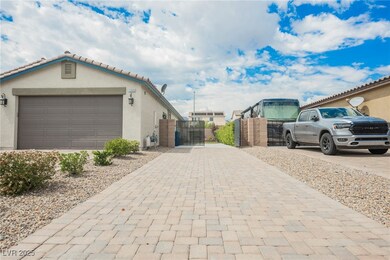View of home's exterior with a gate, stucco siding, and decorative driveway