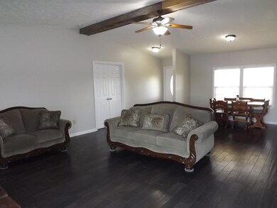 The comfortable great room has a foyer entry, new flooring, new paint & ceiling fan.