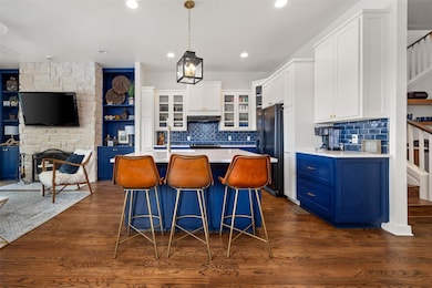 Kitchen featuring dark wood-style floors, light co
