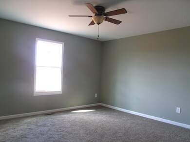Master with carpet, ceiling fan, and it's own full bath.