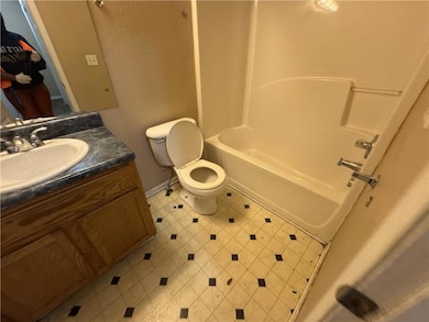 Bathroom with shower / bath combination, toilet, a