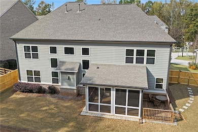Back of house with a fenced backyard and a shingled roof