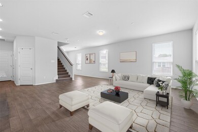 Living area with stairway, wood finished floors, and recessed lighting