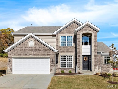 View of front of home with a front lawn and a garage